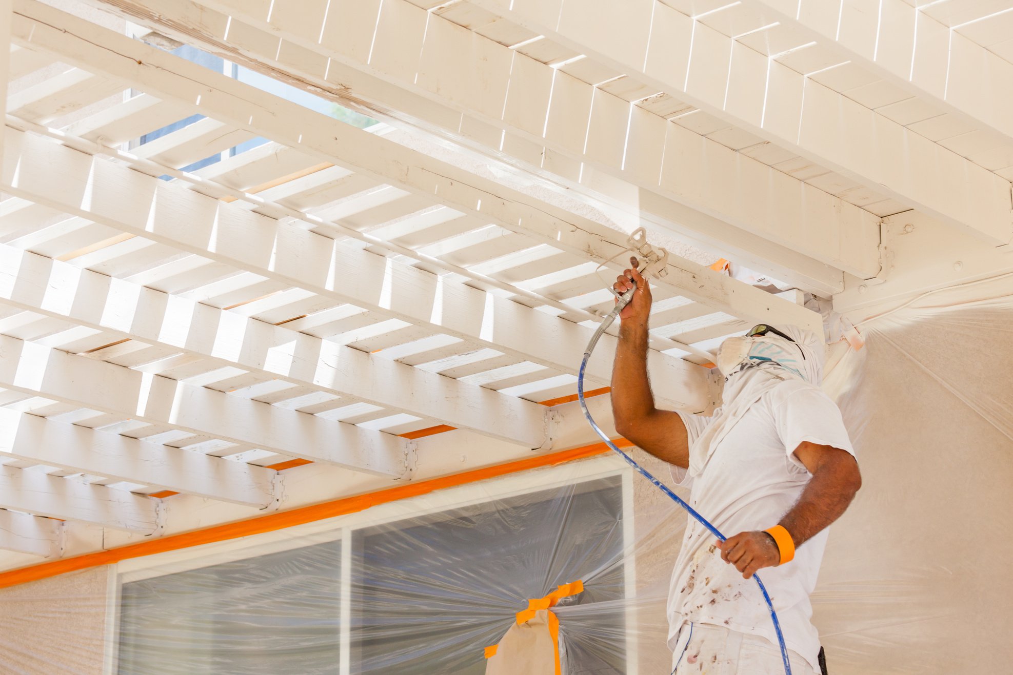 Professional House Painter Wearing Facial Protection Spray Paint